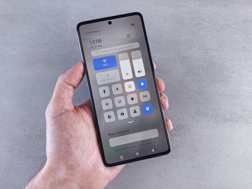 Close-up of a hand holding a smartphone with settings panel visible, focus on screen.